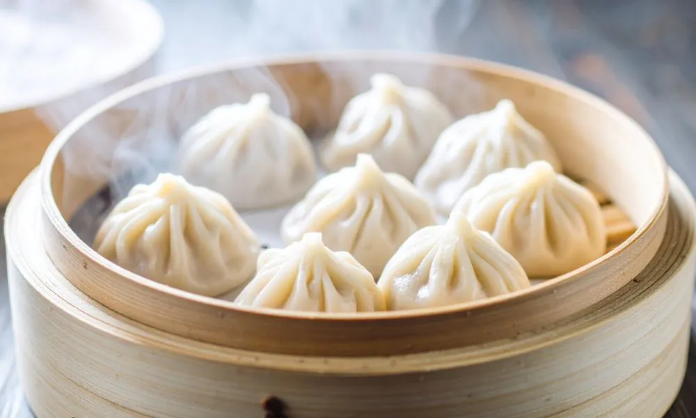 Steaming soup dumplings stacked inside a bamboo steamer basket at Good Alley, a Chinese restaurant in Arcadia